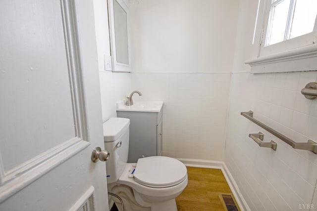 1518 14th St, Lynchburg, VA 24501 - half bathroom with tile walls, wood finished floors, and vanity