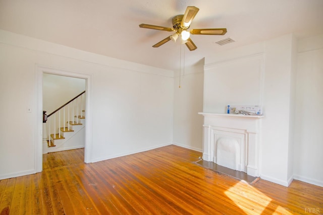 1518 14th St, Lynchburg, VA 24501 - unfurnished living room featuring a ceiling fan, stairs, and wood finished floors