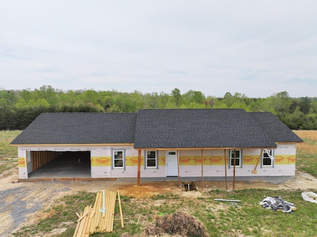 2308 Smith Mountain Lake Pkwy, Huddleston, VA 24104 - unfinished property featuring dirt driveway, roof with shingles, and an attached garage
