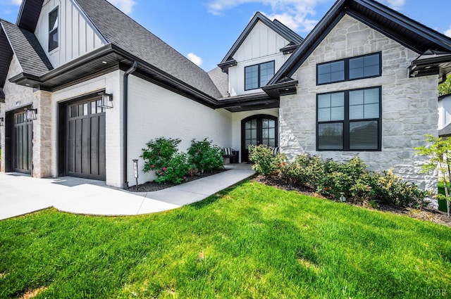 301 Bentley Grove Way, Lynchburg, VA 24502 - view of front facade featuring board and batten siding, stone siding, a front yard, and roof with shingles