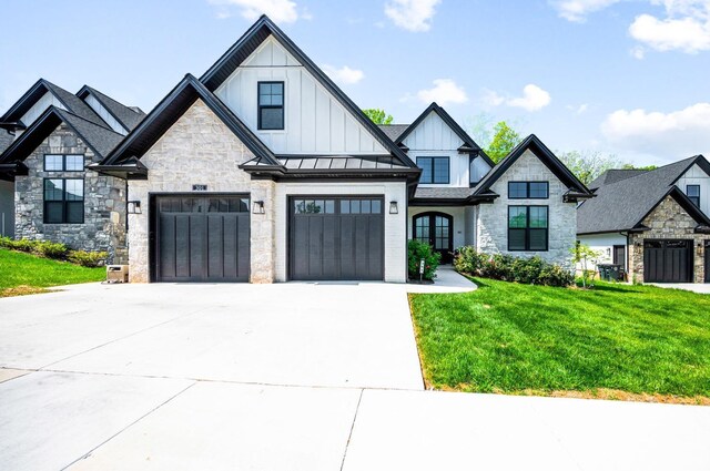 301 Bentley Grove Way, Lynchburg, VA 24502 - view of front of property featuring board and batten siding, concrete driveway, a front lawn, and stone siding
