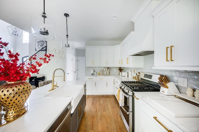 301 Bentley Grove Way, Lynchburg, VA 24502 - kitchen with appliances with stainless steel finishes, wall chimney exhaust hood, tasteful backsplash, light stone countertops, and white cabinets