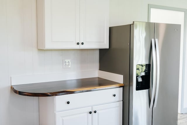 3677 Grit Rd, Hurt, VA 24563 - kitchen with stainless steel fridge, white cabinetry, and dark countertops