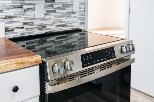 3677 Grit Rd, Hurt, VA 24563 - kitchen view of stainless steel range with electric stovetop and tasteful backsplash