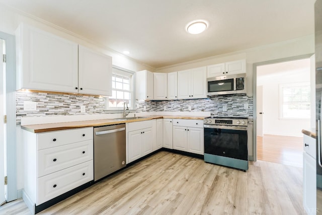 3677 Grit Rd, Hurt, VA 24563 - kitchen featuring stainless steel appliances, a sink, light wood-style floors, and ornamental molding