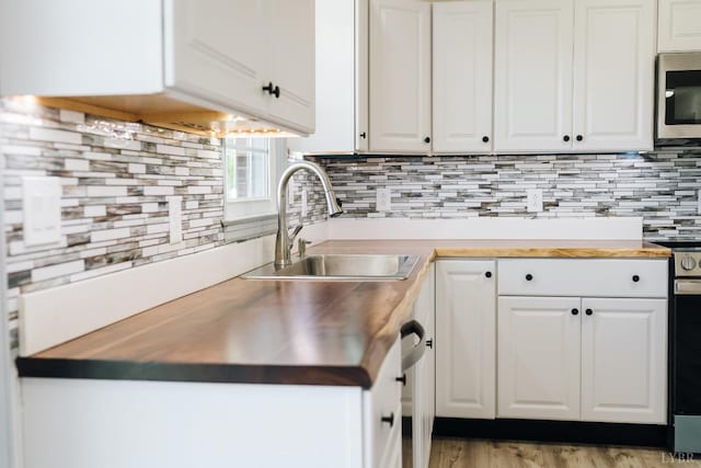 3677 Grit Rd, Hurt, VA 24563 - kitchen with stainless steel microwave, wood counters, and white cabinetry