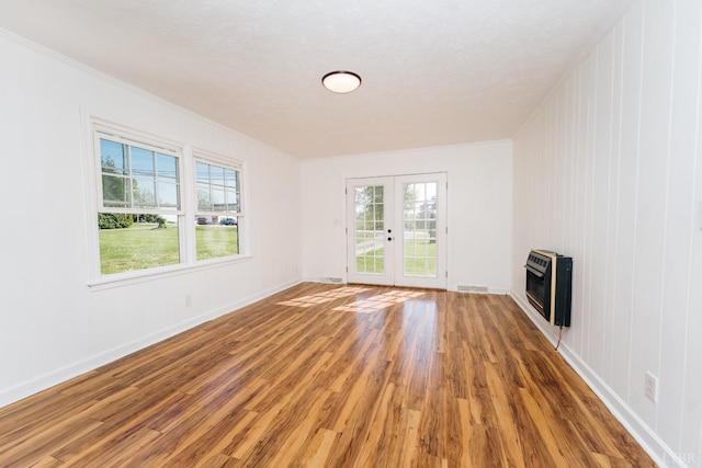3677 Grit Rd, Hurt, VA 24563 - unfurnished living room with heating unit, wood finished floors, ornamental molding, french doors, and baseboards