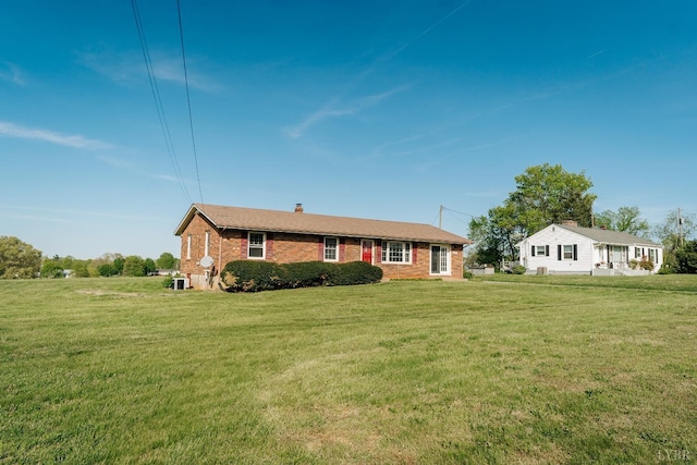 3677 Grit Rd, Hurt, VA 24563 - view of front of home with brick siding, a front yard, and a chimney