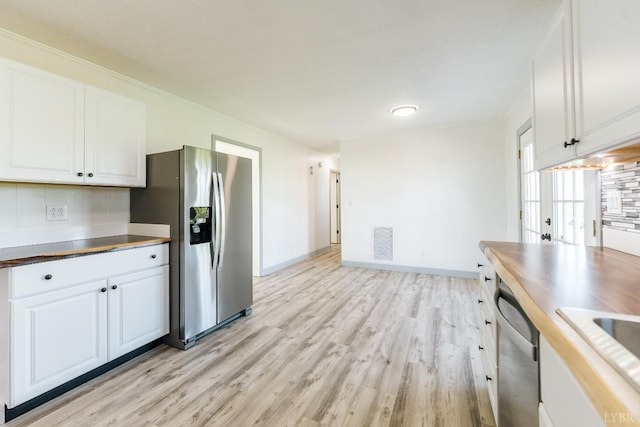 3677 Grit Rd, Hurt, VA 24563 - kitchen with appliances with stainless steel finishes, light wood-style flooring, white cabinetry, baseboards, and crown molding