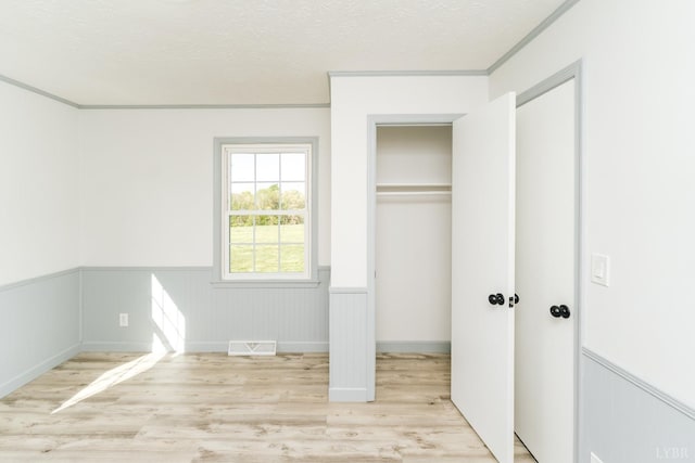 3677 Grit Rd, Hurt, VA 24563 - unfurnished bedroom featuring light wood-type flooring, a wainscoted wall, and ornamental molding
