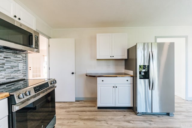 3677 Grit Rd, Hurt, VA 24563 - kitchen with appliances with stainless steel finishes, ornamental molding, light wood-style floors, and white cabinets