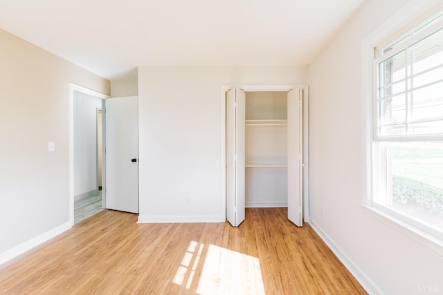 3677 Grit Rd, Hurt, VA 24563 - unfurnished bedroom with light wood-type flooring, multiple windows, and baseboards
