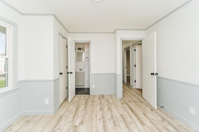 3677 Grit Rd, Hurt, VA 24563 - unfurnished bedroom featuring a wainscoted wall, light wood finished floors, crown molding, and ensuite bath