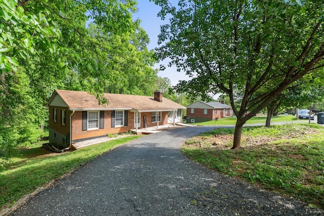 119 Adams Dr, Lynchburg, VA 24502 - single story home with brick siding, a chimney, asphalt driveway, and a porch