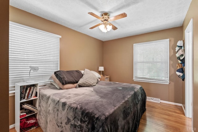 119 Adams Dr, Lynchburg, VA 24502 - bedroom with wood finished floors, baseboards, a textured ceiling, and ceiling fan