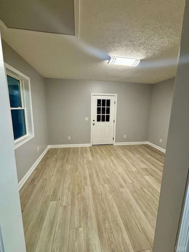 1172 Golden Leaf Rd, Nathalie, VA 24577 - unfurnished room with light wood-type flooring, baseboards, and a textured ceiling