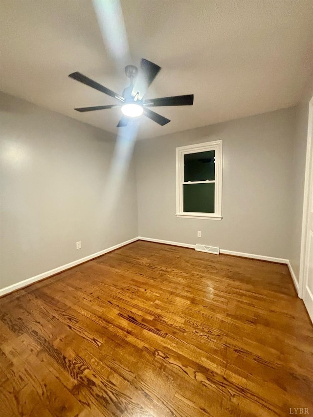 1172 Golden Leaf Rd, Nathalie, VA 24577 - unfurnished room featuring a ceiling fan, wood finished floors, and baseboards