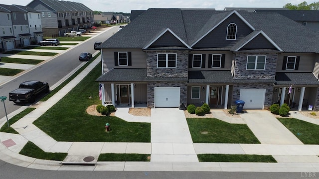 view of property featuring a garage, stone siding, roof with shingles, concrete driveway, and a residential view