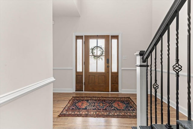 foyer entrance with wood finished floors and stairway