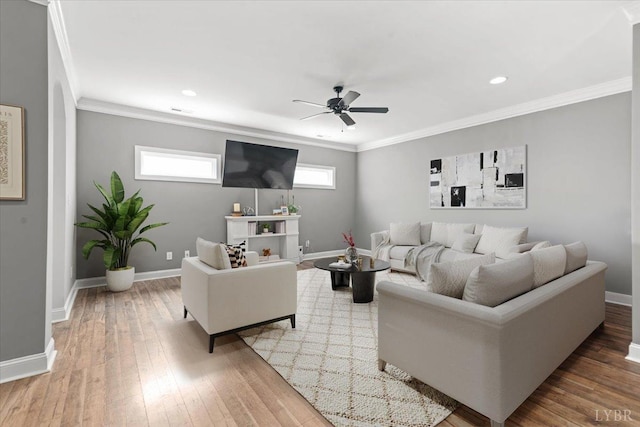 living area with crown molding, baseboards, a ceiling fan, and wood finished floors