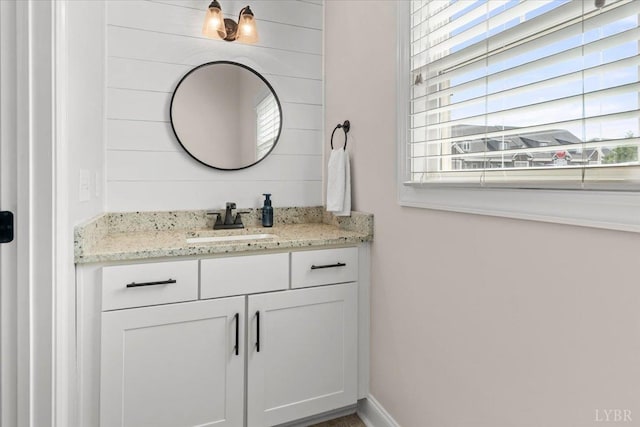 bathroom featuring a healthy amount of sunlight and vanity