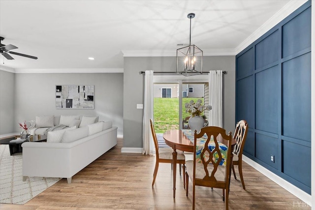 dining space featuring crown molding, recessed lighting, and wood finished floors