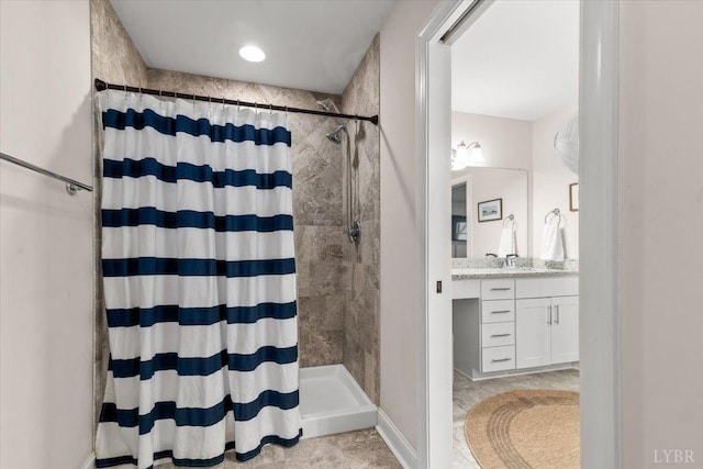 bathroom with vanity, tile patterned flooring, and a tile shower
