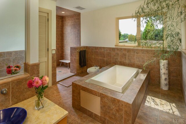 1209 Sycamore Creek Dr, Goode, VA 24556 - bathroom featuring visible vents, a closet, tile walls, tile patterned floors, and a bath