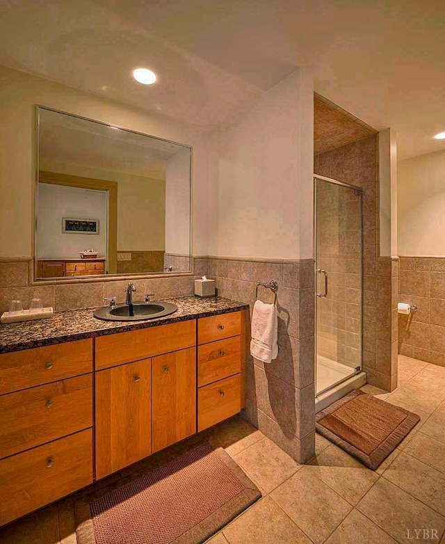1209 Sycamore Creek Dr, Goode, VA 24556 - full bath featuring tile walls, a shower stall, a wainscoted wall, vanity, and tile patterned floors