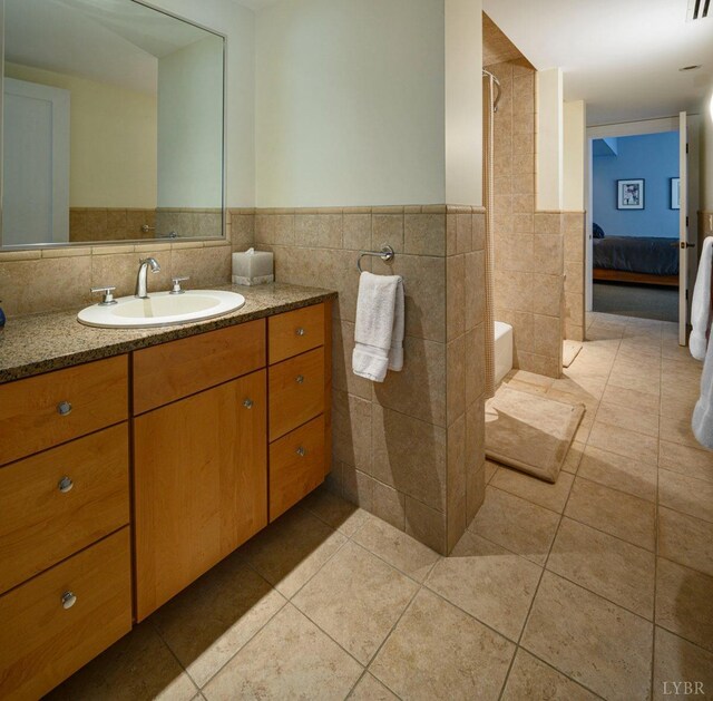 1209 Sycamore Creek Dr, Goode, VA 24556 - bathroom with tile walls, wainscoting, tile patterned flooring, and vanity