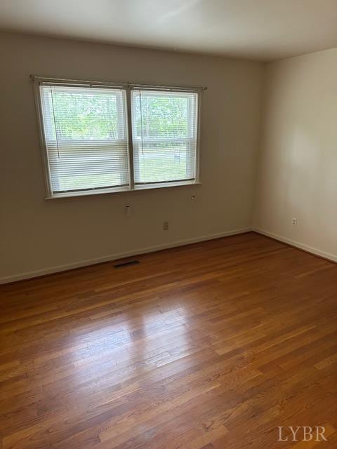 116 Carson St, Brookneal, VA 24528 - spare room featuring wood finished floors and baseboards