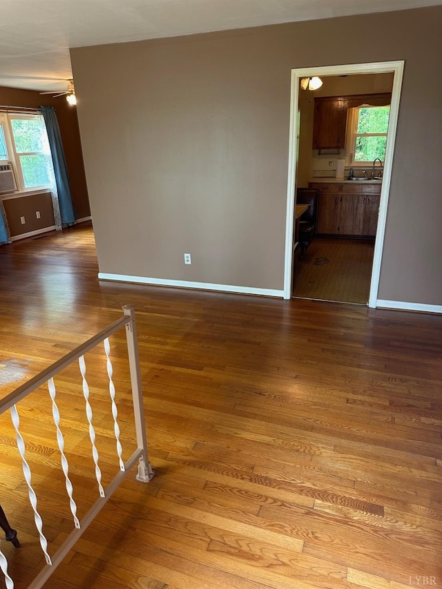 116 Carson St, Brookneal, VA 24528 - unfurnished living room featuring wood finished floors, baseboards, and a sink