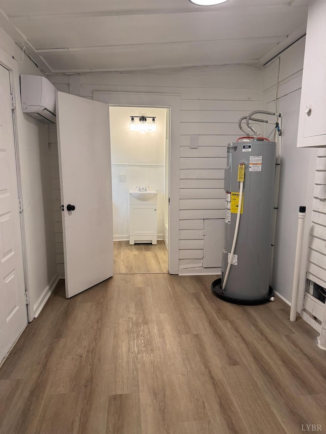 1305 Campbell Ave, Lynchburg, VA 24501 - utility room with electric water heater, an AC wall unit, and a sink