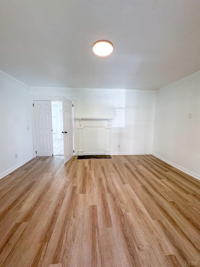 1305 Campbell Ave, Lynchburg, VA 24501 - unfurnished living room featuring light wood-style flooring, baseboards, and ornamental molding