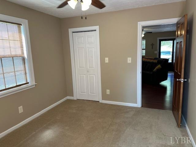 301 Gooseneck Ct, Forest, VA 24551 - unfurnished bedroom featuring light colored carpet, a closet, and a ceiling fan