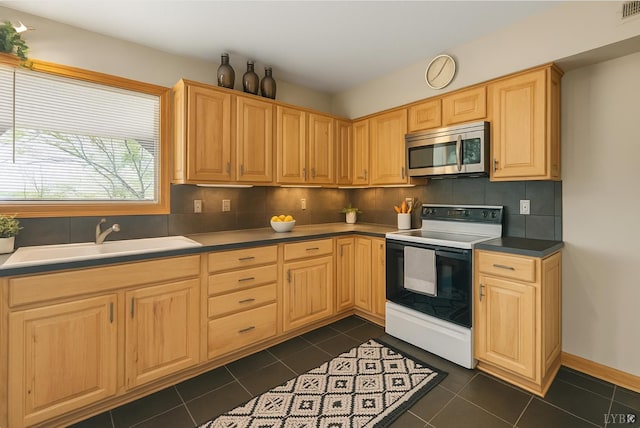 106 Catlett Ct, Moneta, VA 24121 - kitchen with stainless steel microwave, range with electric stovetop, light brown cabinetry, tasteful backsplash, and dark tile patterned flooring