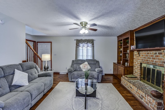 1529 Bateman Bridge Rd, Forest, VA 24551 - living room with a brick fireplace, dark wood-style floors, stairway, a ceiling fan, and a textured ceiling