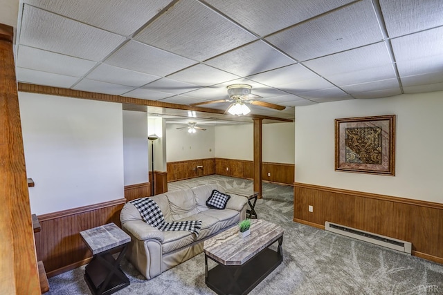 1529 Bateman Bridge Rd, Forest, VA 24551 - living room featuring a baseboard heating unit, a wainscoted wall, wooden walls, and a paneled ceiling