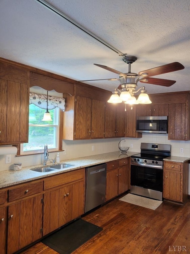 1529 Bateman Bridge Rd, Forest, VA 24551 - kitchen featuring a textured ceiling, a sink, appliances with stainless steel finishes, a ceiling fan, and brown cabinetry