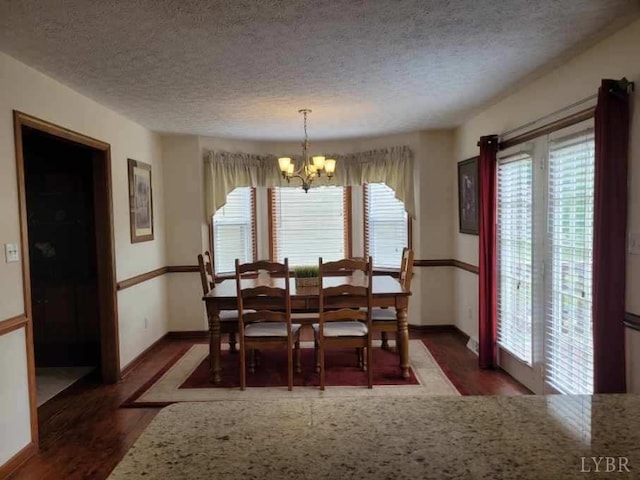 1529 Bateman Bridge Rd, Forest, VA 24551 - dining area with baseboards, wood finished floors, a notable chandelier, and a textured ceiling