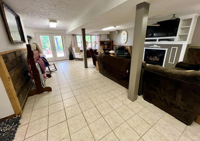 216 Burford Farm Rd, Monroe, VA 24574 - living room featuring a fireplace, a textured ceiling, light tile patterned flooring, and french doors