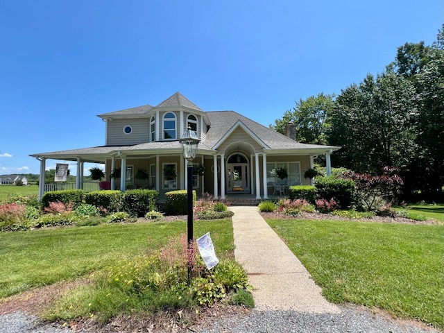 216 Burford Farm Rd, Monroe, VA 24574 - victorian-style house featuring covered porch, a front yard, a chimney, and a shingled roof