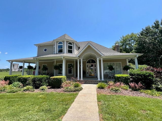 216 Burford Farm Rd, Monroe, VA 24574 - victorian home with covered porch, a front lawn, and a chimney