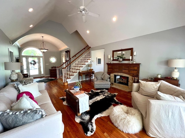 216 Burford Farm Rd, Monroe, VA 24574 - living room featuring lofted ceiling, arched walkways, stairs, wood finished floors, and a premium fireplace