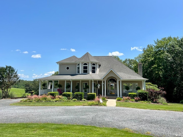 216 Burford Farm Rd, Monroe, VA 24574 - view of front of home with covered porch, a chimney, and a front lawn