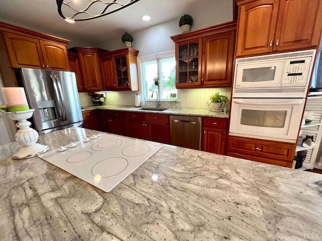 216 Burford Farm Rd, Monroe, VA 24574 - kitchen with appliances with stainless steel finishes, tasteful backsplash, glass insert cabinets, and light stone countertops
