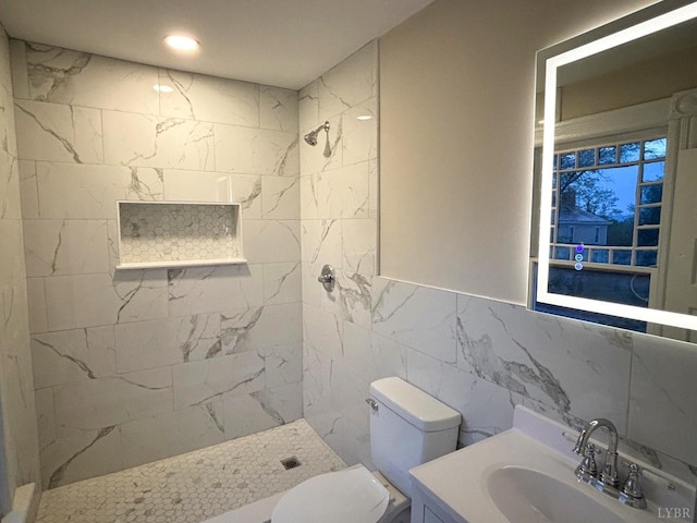 850 Rivermont Ave, Lynchburg, VA 24504 - bathroom featuring a tile shower, toilet, vanity, and tile walls