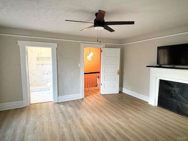 850 Rivermont Ave, Lynchburg, VA 24504 - unfurnished living room with ceiling fan, wood finished floors, baseboards, and a fireplace