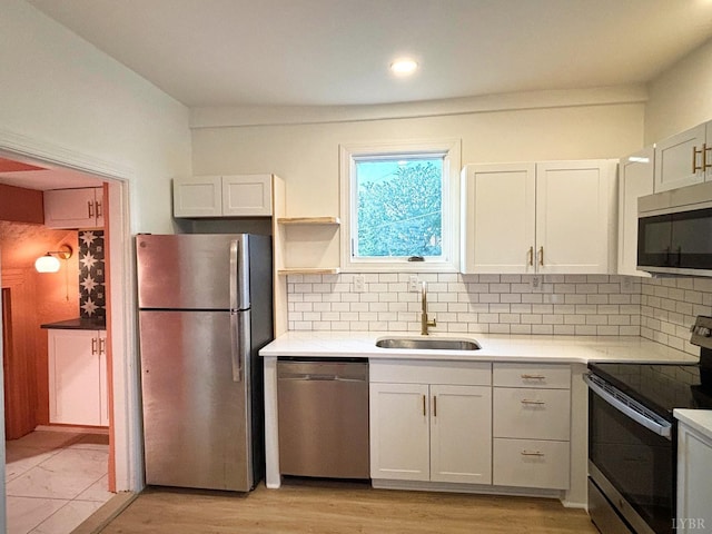 850 Rivermont Ave, Lynchburg, VA 24504 - kitchen with stainless steel appliances, a sink, light countertops, decorative backsplash, and recessed lighting