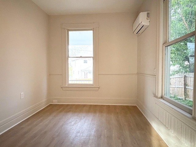 850 Rivermont Ave, Lynchburg, VA 24504 - empty room featuring a wall mounted air conditioner, wood finished floors, healthy amount of natural light, and baseboards